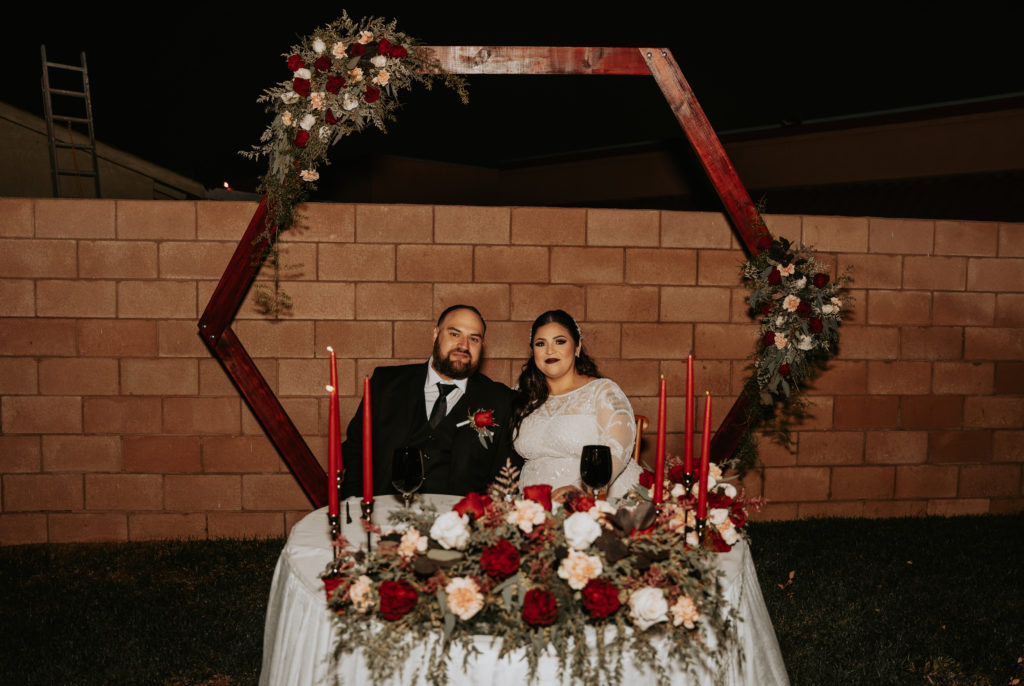 bride and groom photos at sweetheart table during reception