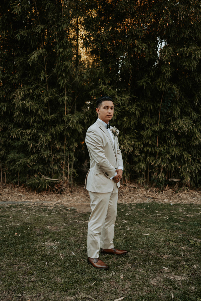 photo of groom wearing nude colored suit