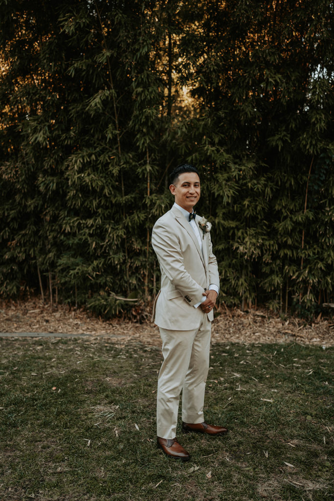 photo of groom wearing nude colored suit