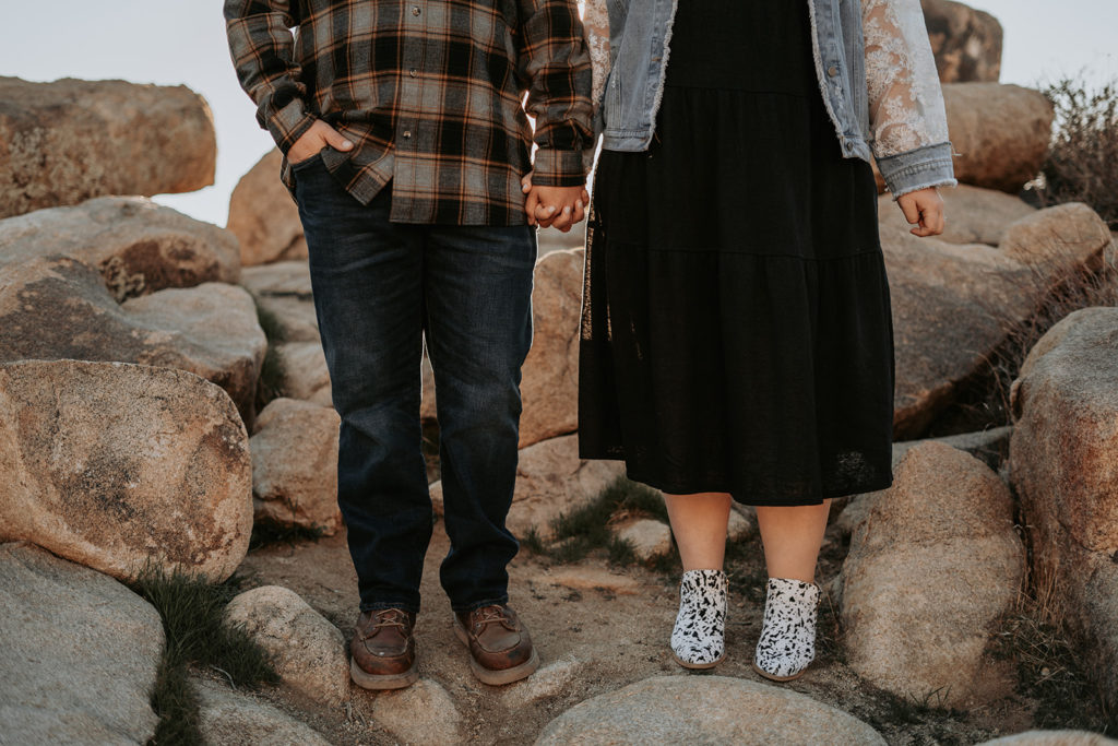 couple holding hands at desert