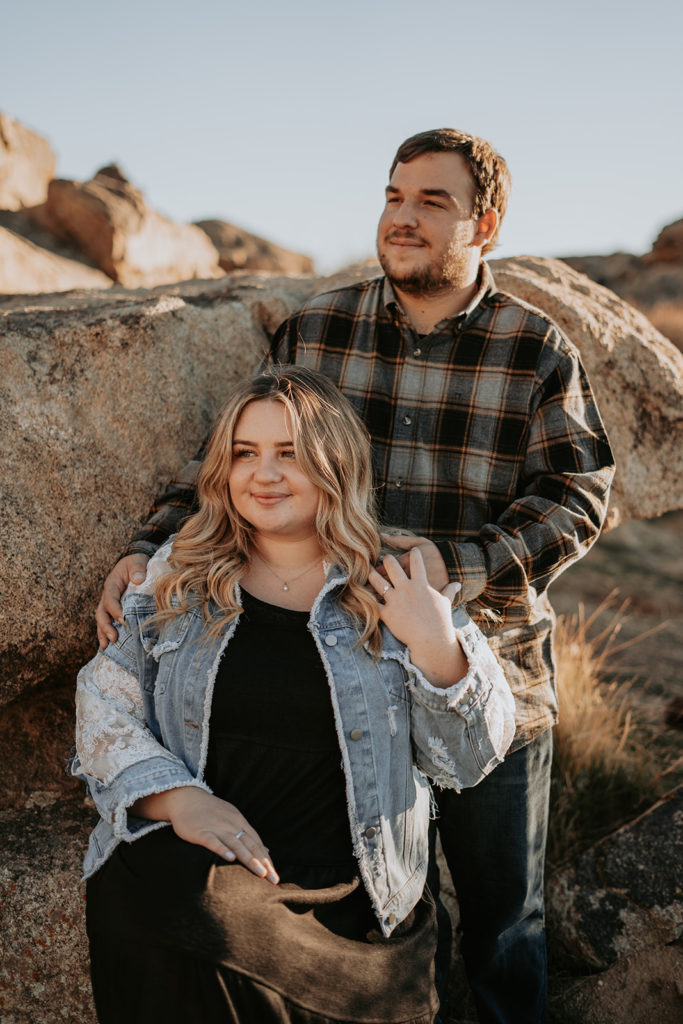 engagement photos sitting on rocks in desert