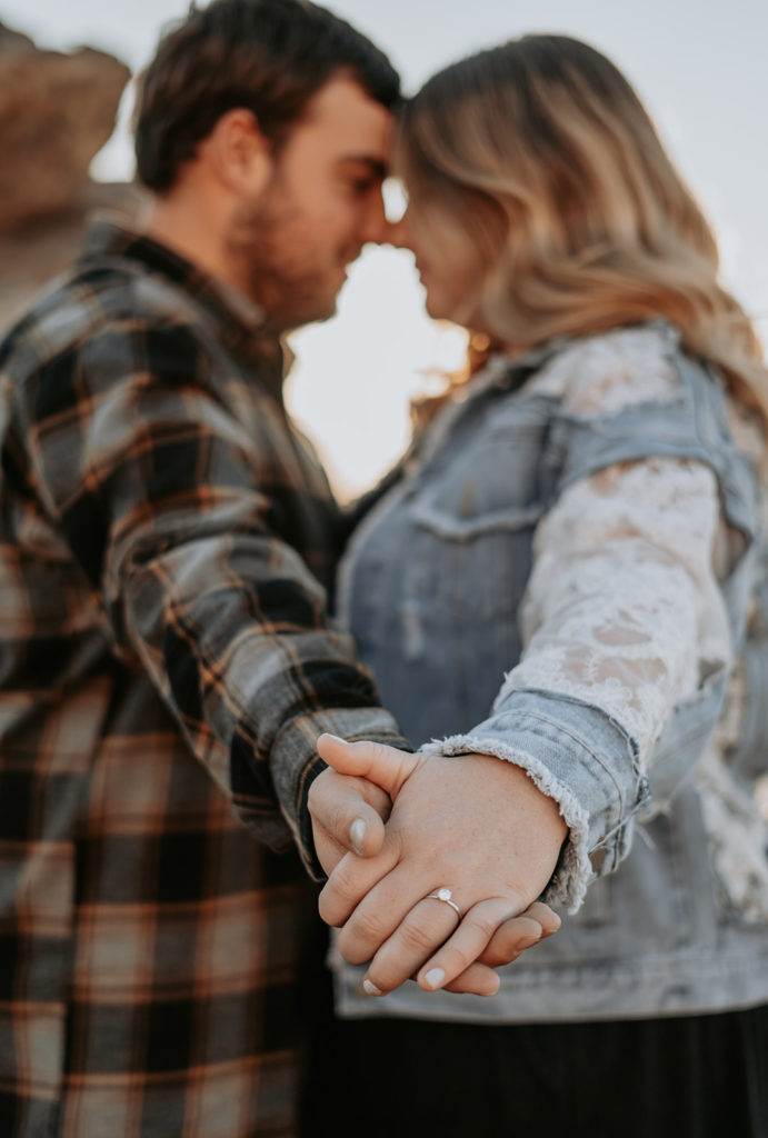 couple holding hands during engagement photos