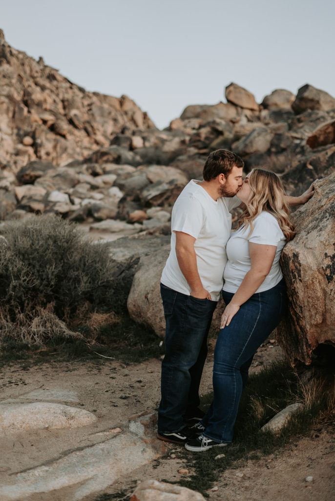 couple standing on rocks at engagement photos