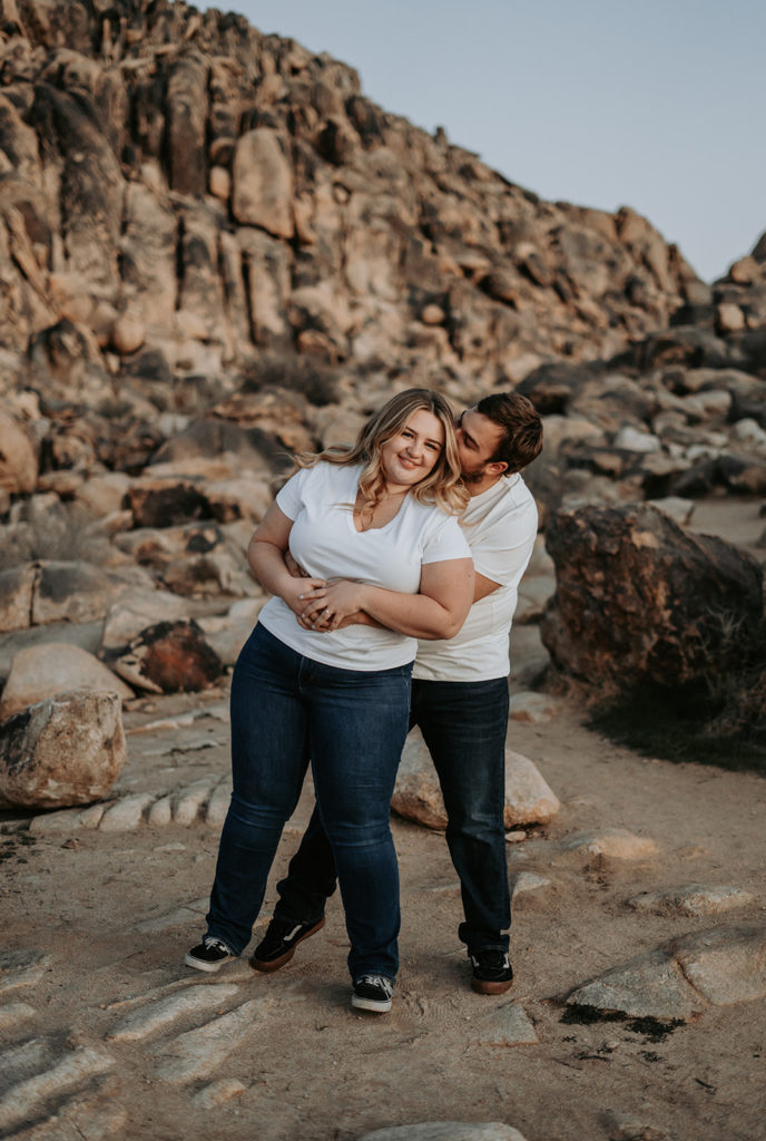 couple standing on rocks at engagement photos