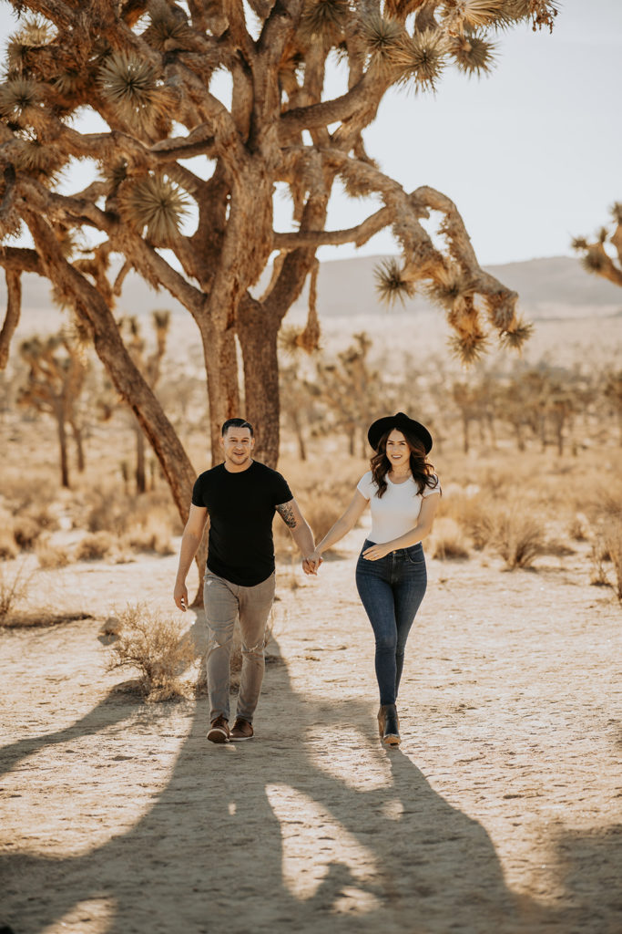 couple walking holding hands at engagement session