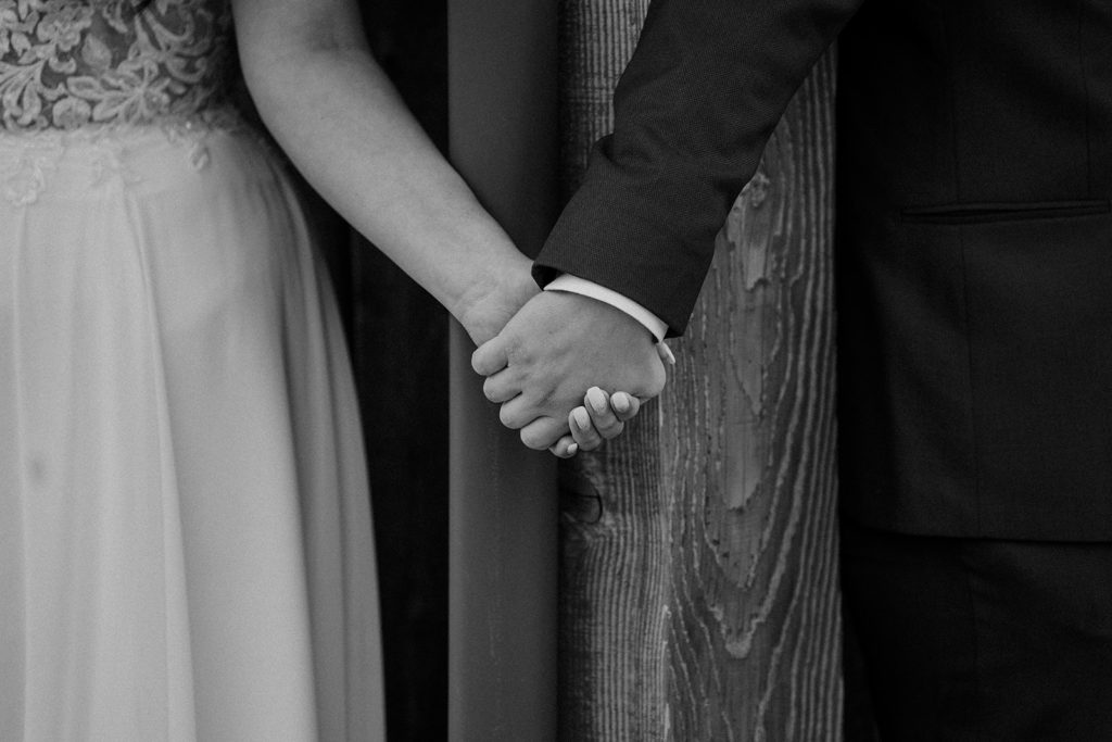 bride and groom holding hands before their first look