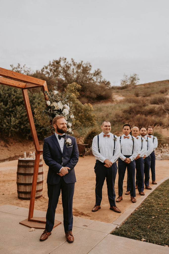 groom and groomsmen waiting at the alter