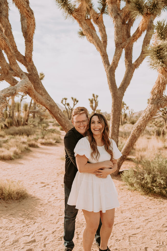couple posing in joshua tree for their engagement photos