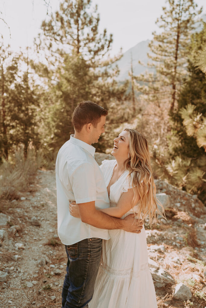 couple in forest falls ca posing for their engagement photos in the mountains
