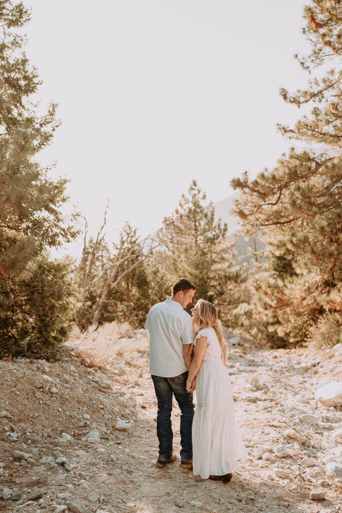 Couple posing for their engagement photos in forest falls ca - rustic engagement photos
