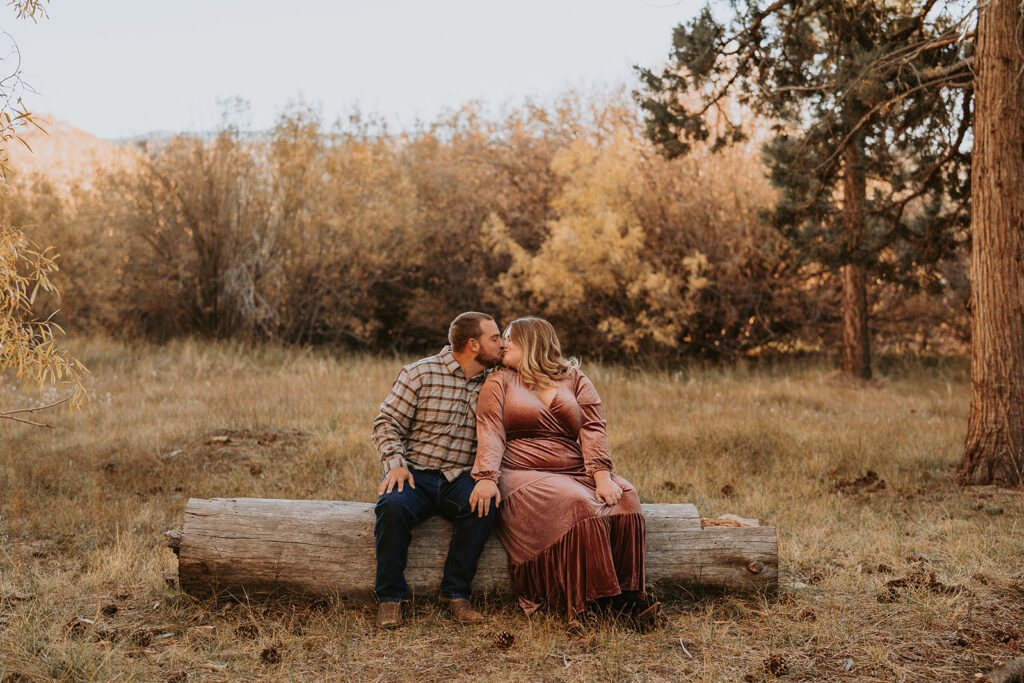 couple sitting for fall engagement session