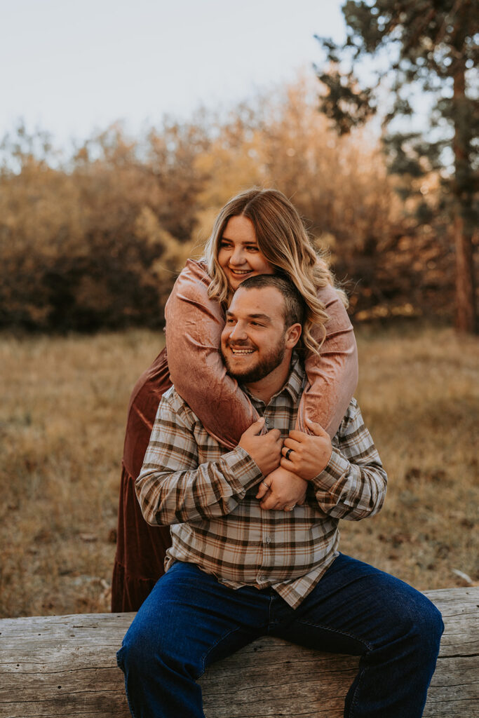 couple smiling for fall engagement session