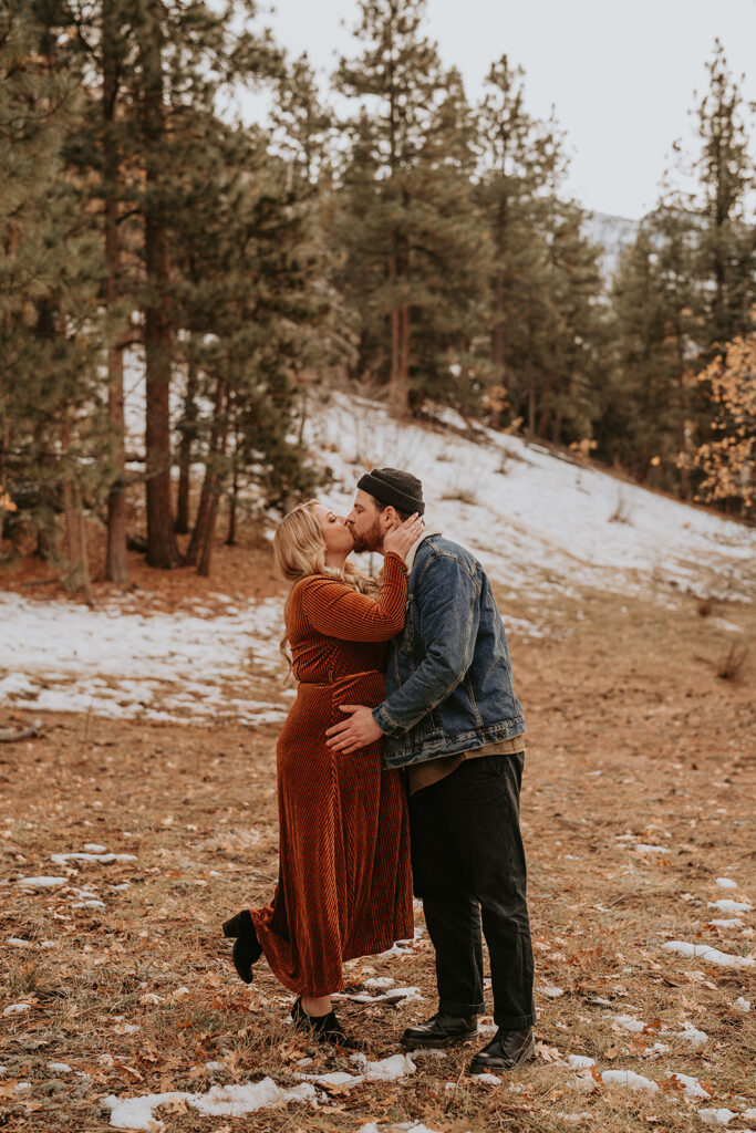couple kissing for fall mountain engagement session