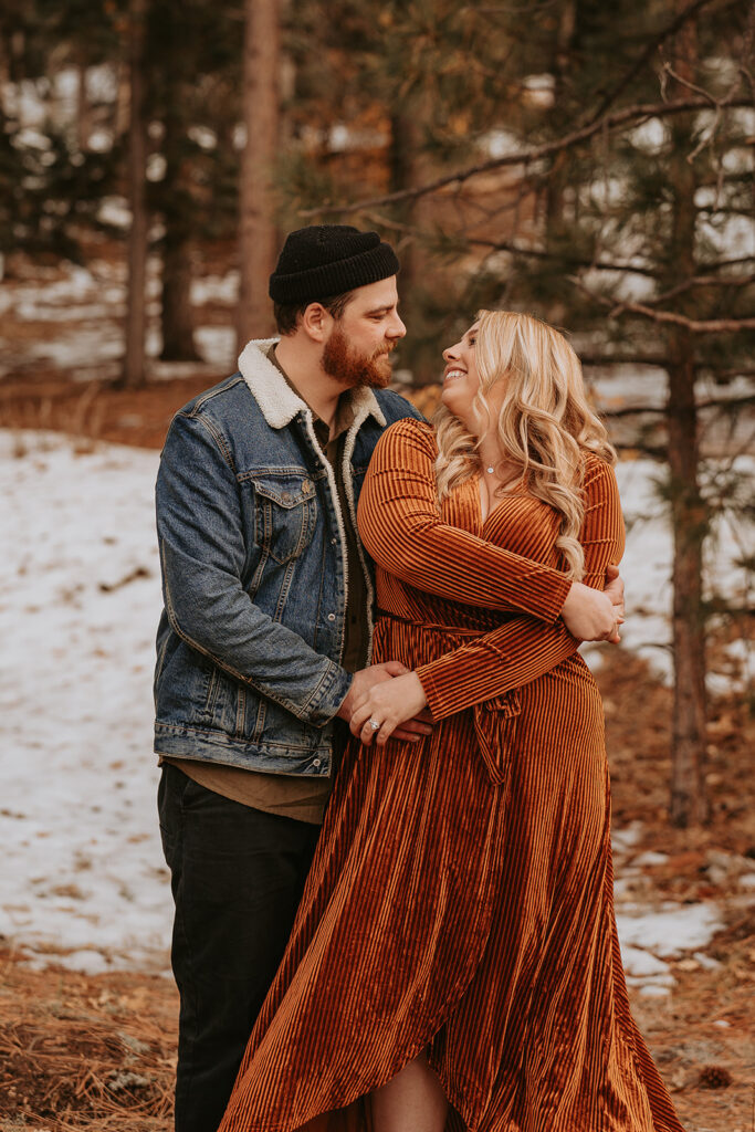 Couple spinning in the winter mountain engagement