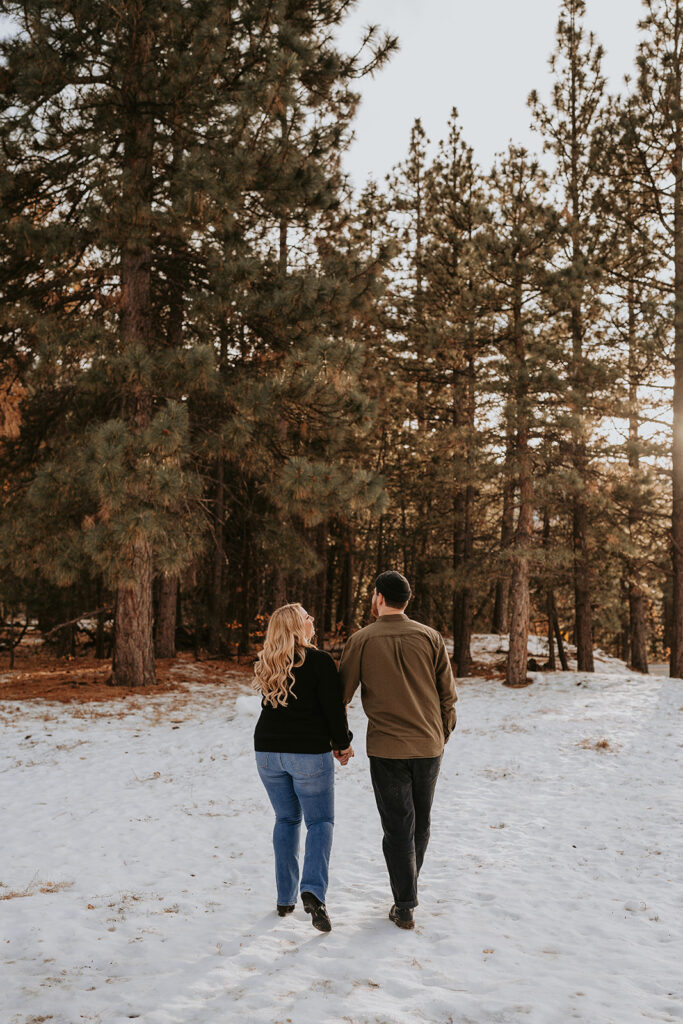 couple walking for winter engagement session