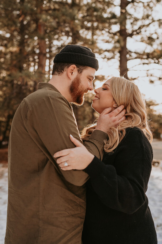 couple kissing for winter engagement session