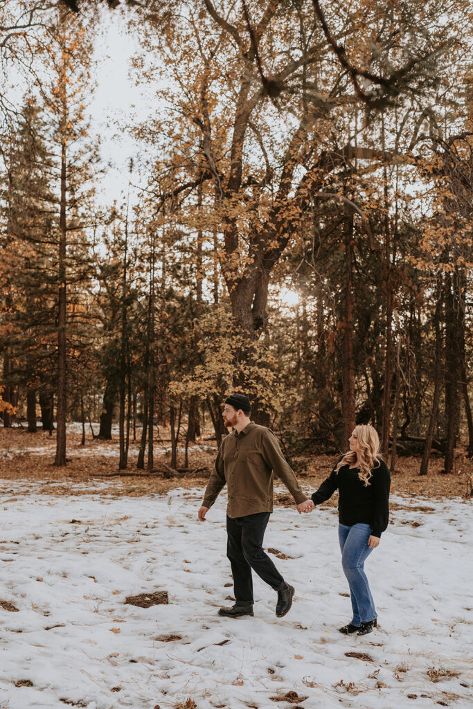 couple walking for winter engagement session