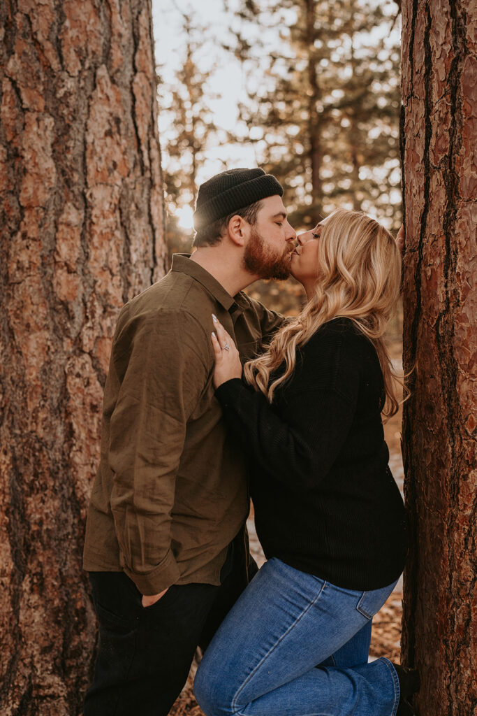 couple kissing for winter engagement session