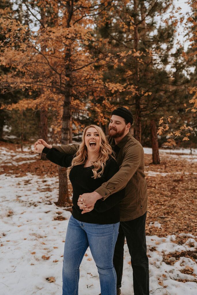 couple laughing for winter engagement session