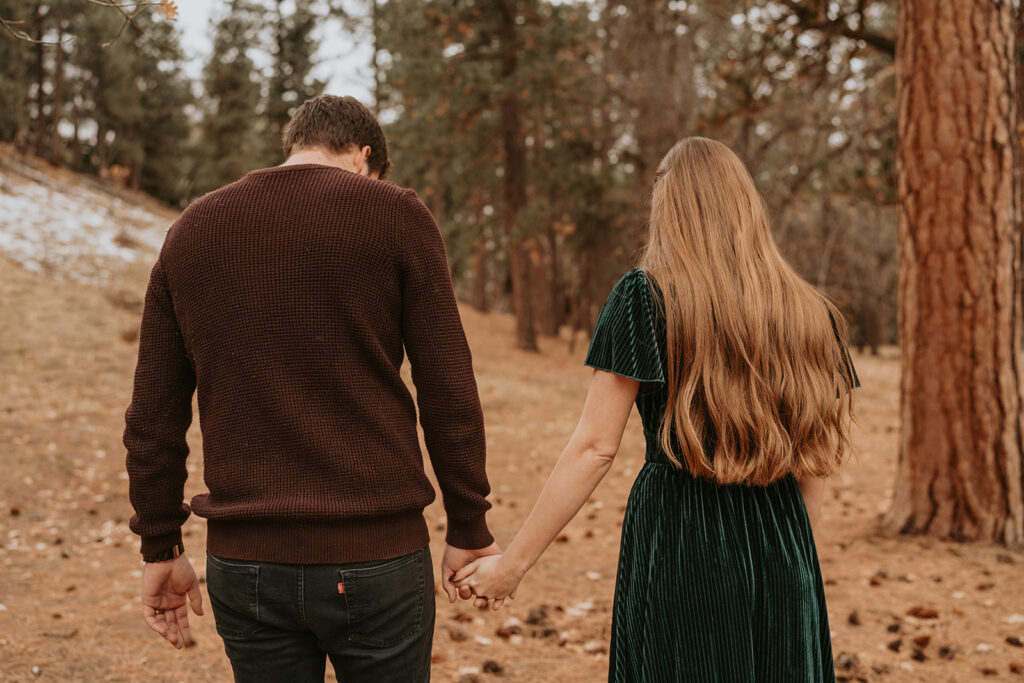 Engagement couple holding hands in the fall in the mountains