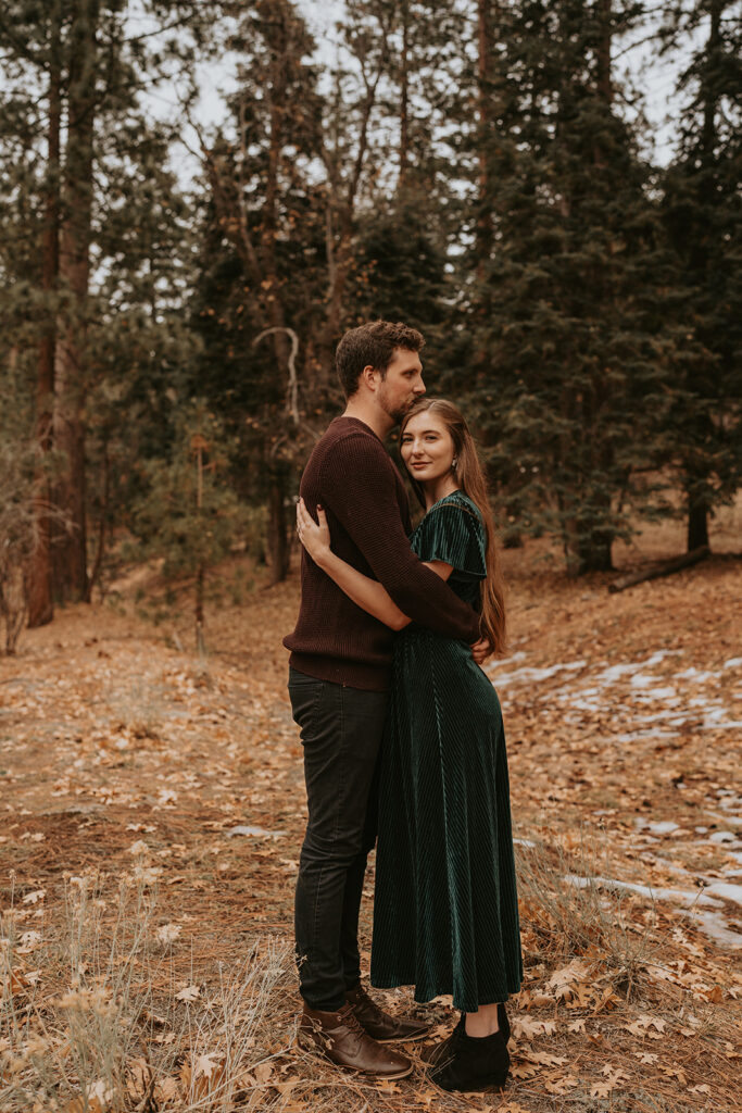 couple embracing in winter mountain engagement