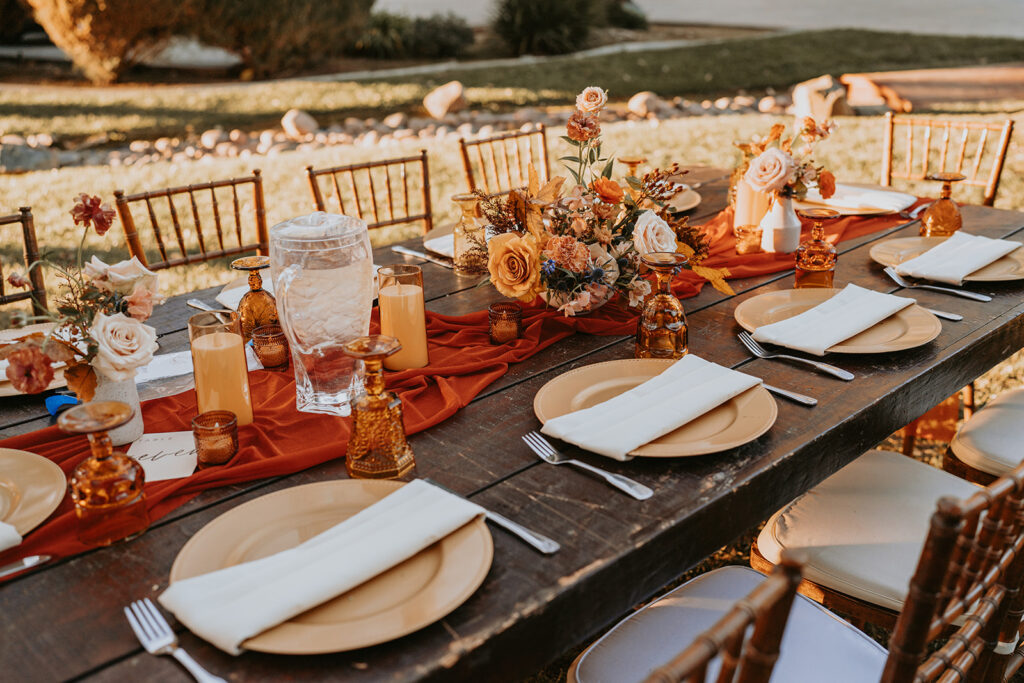 orange wedding table decor and florals