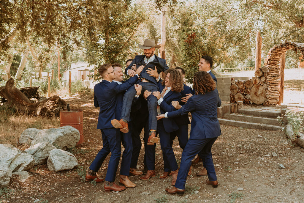 Groomsmen jumping and laughing
