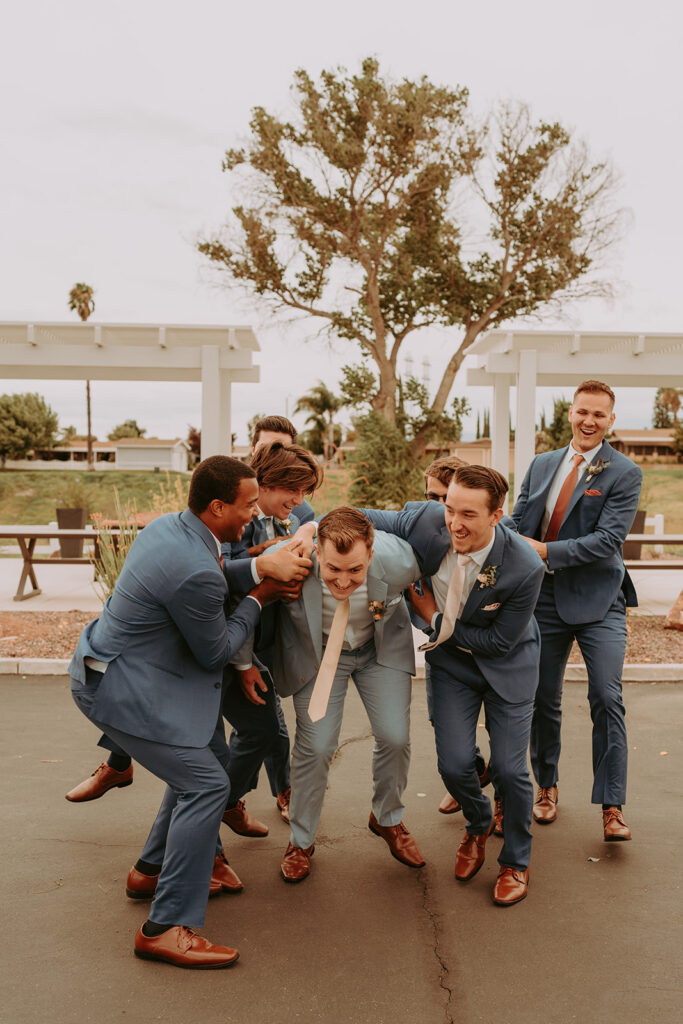 Groomsmen jumping and laughing
