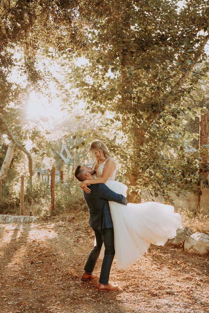 groom spinning a bride at a Southern California wedding venue in Oak Glen
