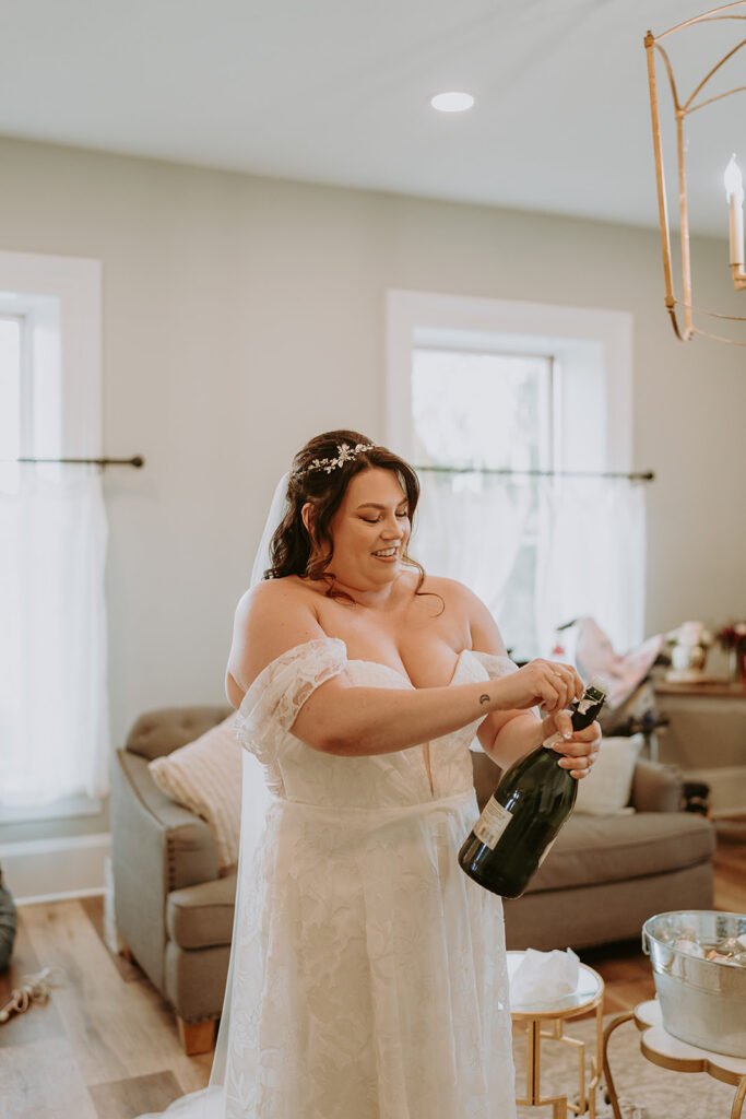 bride popping champagne bottle at the barton house in redlands