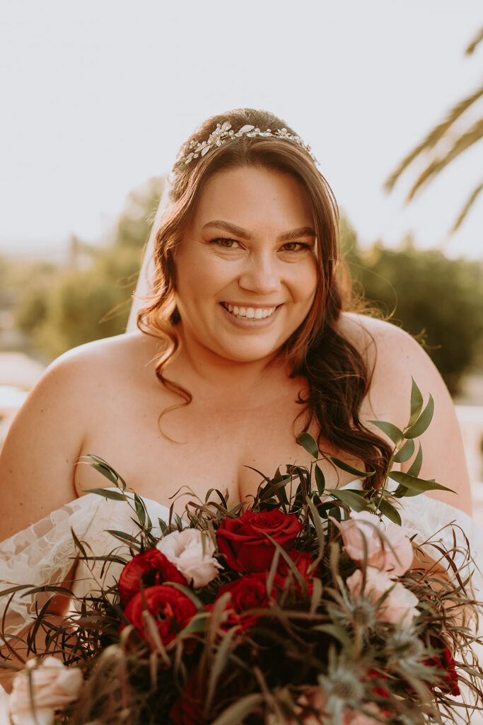 bride with a large red and green bouquet 