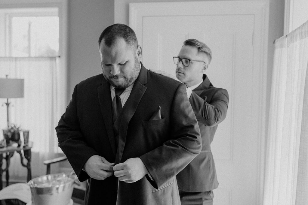 black and white groom getting ready