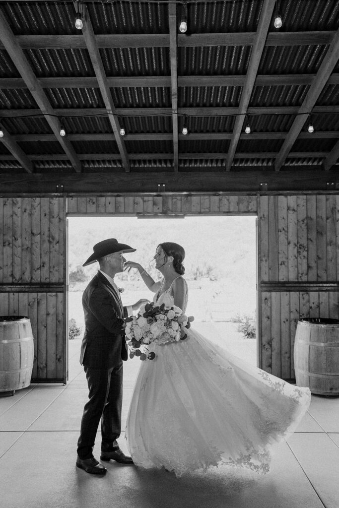 bride and groom dancing in a barn