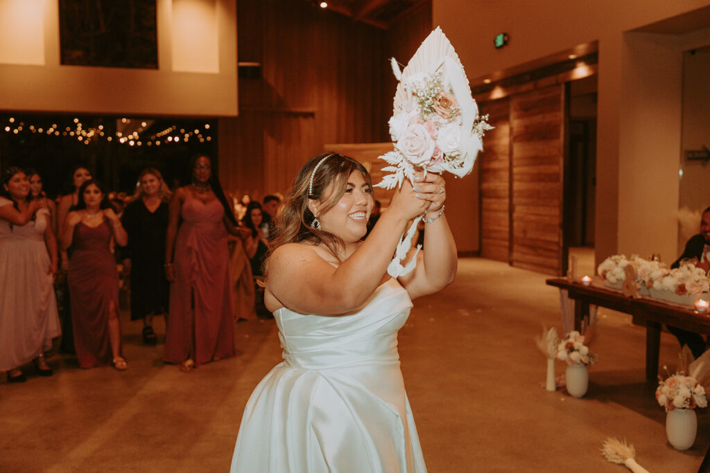 bride throwing the bouquet at a wedding