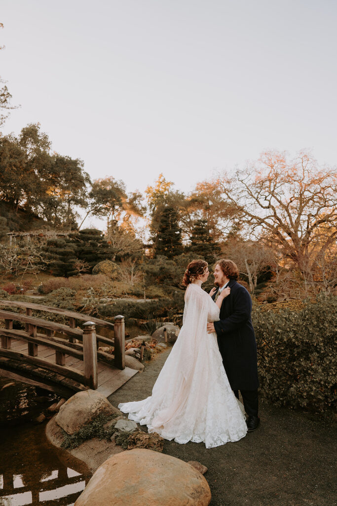 bride and groom embracing outside in a Japanese garden