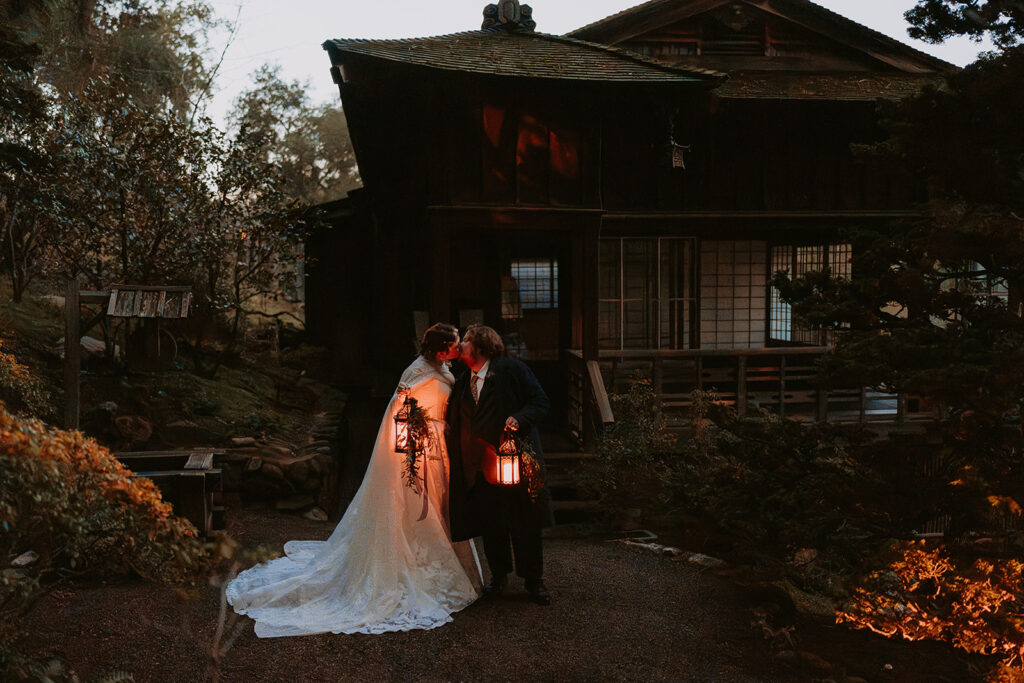 bride and groom outside at night with lanterns