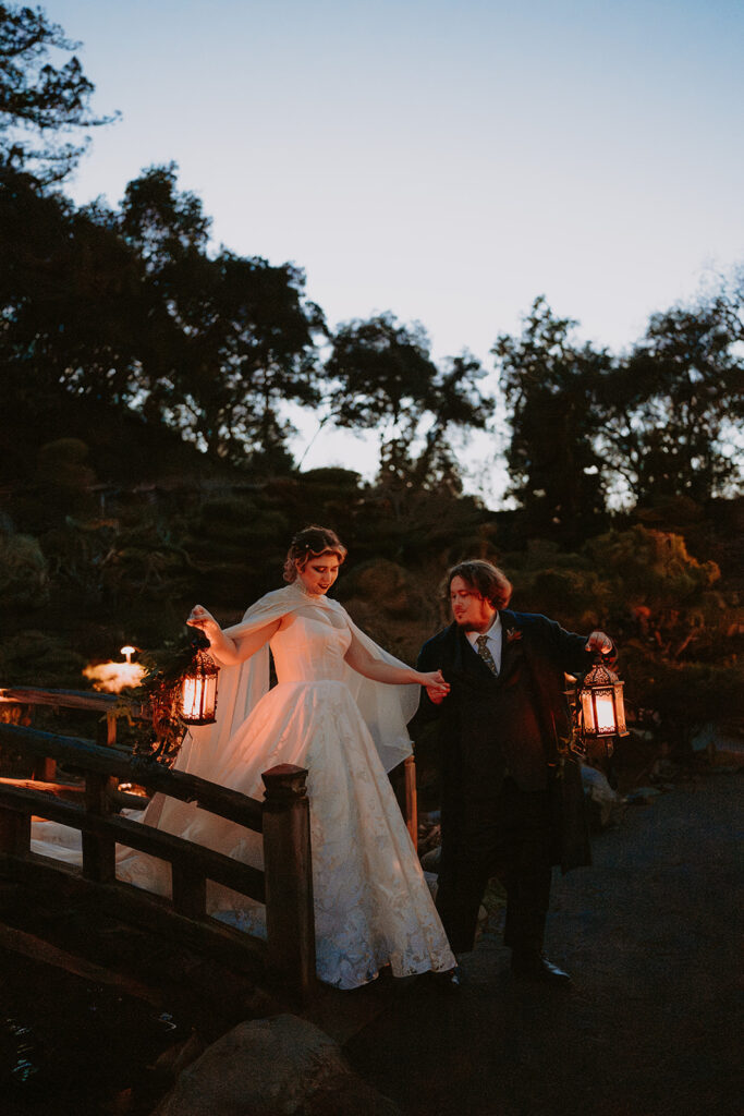 bride and groom outside at night with lanterns