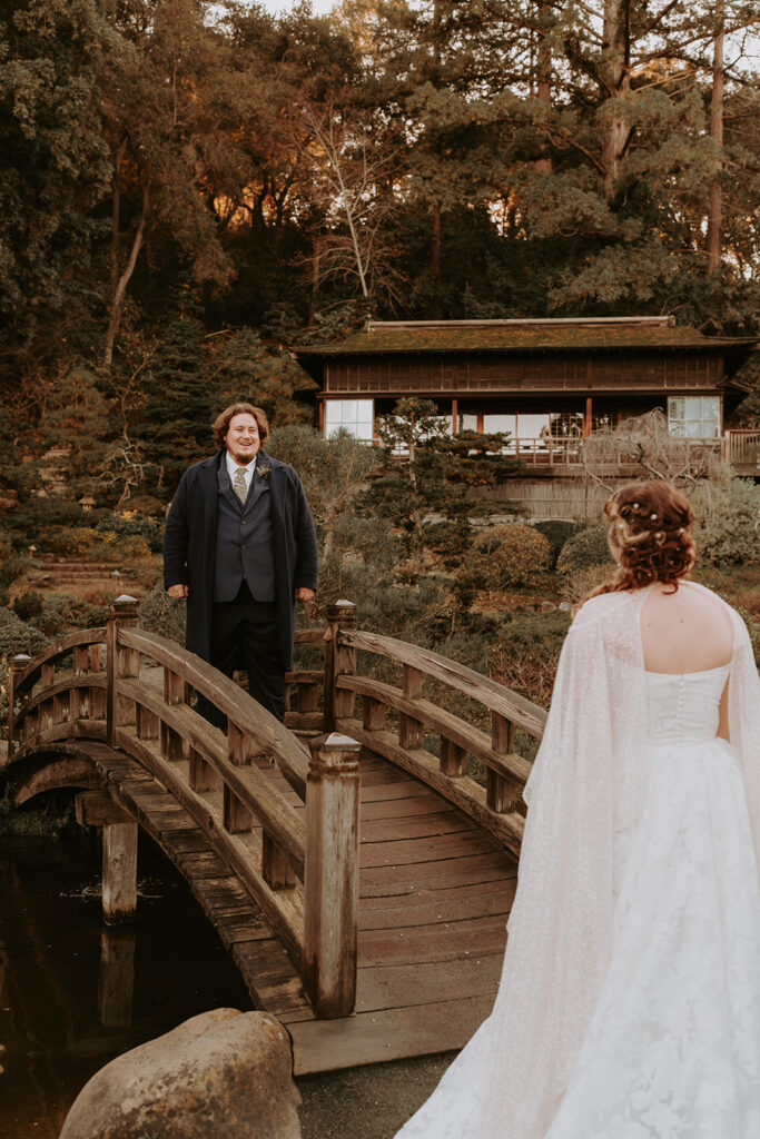 bride and groom first look outside on a bridge