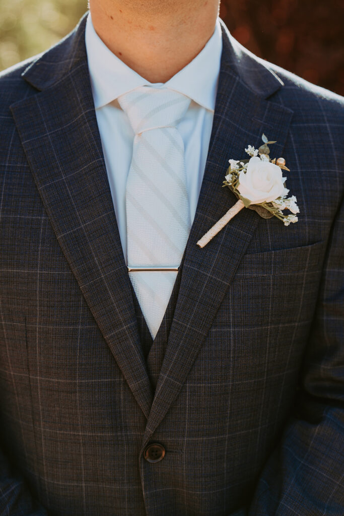 close up of a groom wearing boutonniere