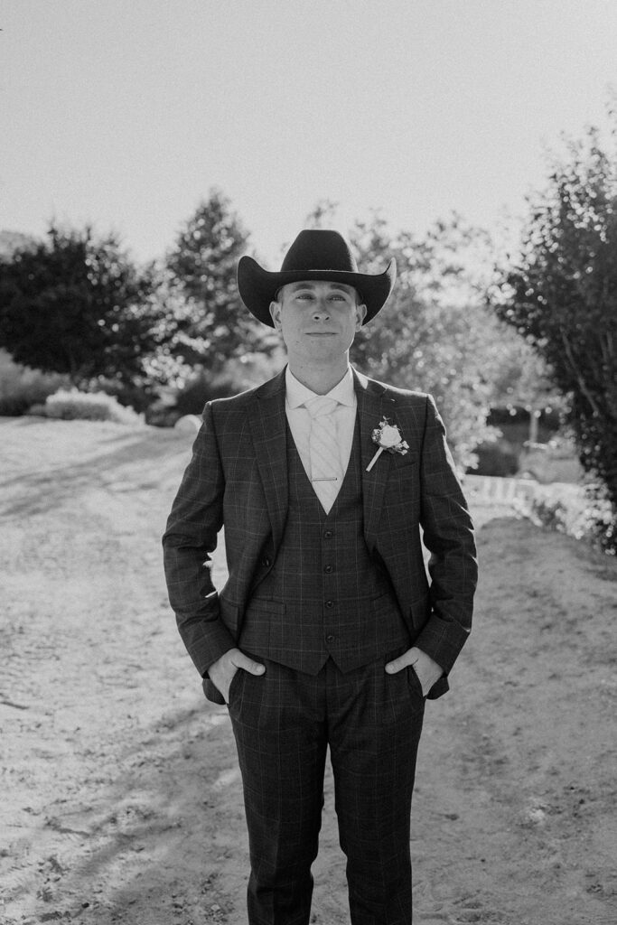Black and white photos of a groom in a cowboy hat
