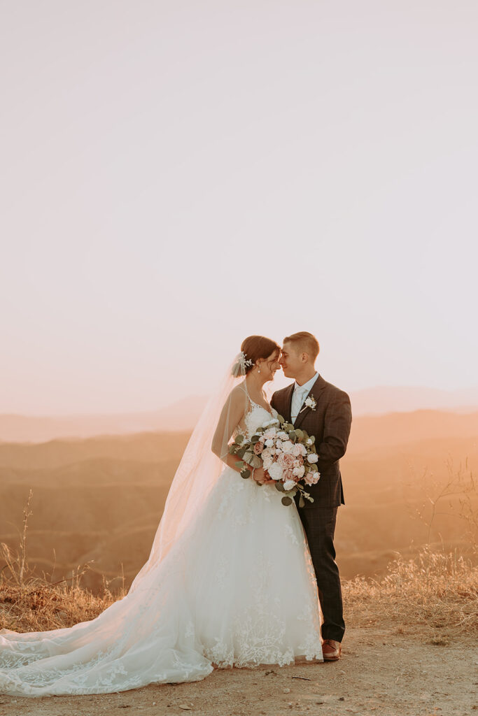 Bride and groom taking sunset photos at windmill canyon ranch
