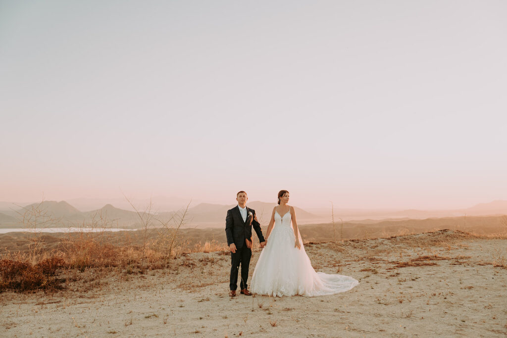 wide shot of bride and groom sunset photos