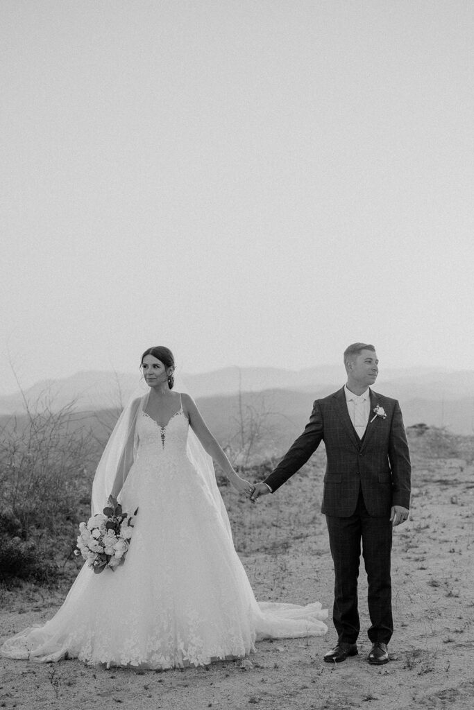 black and white sunset photo of bride and groom