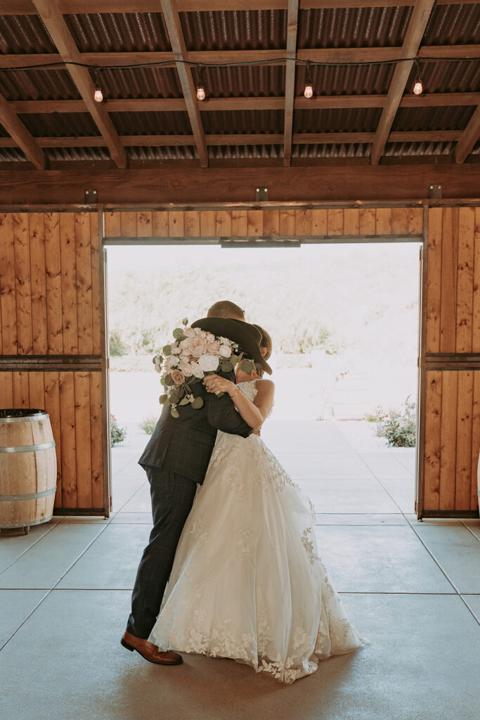 Bride and groom kissing at windmill canyon ranch