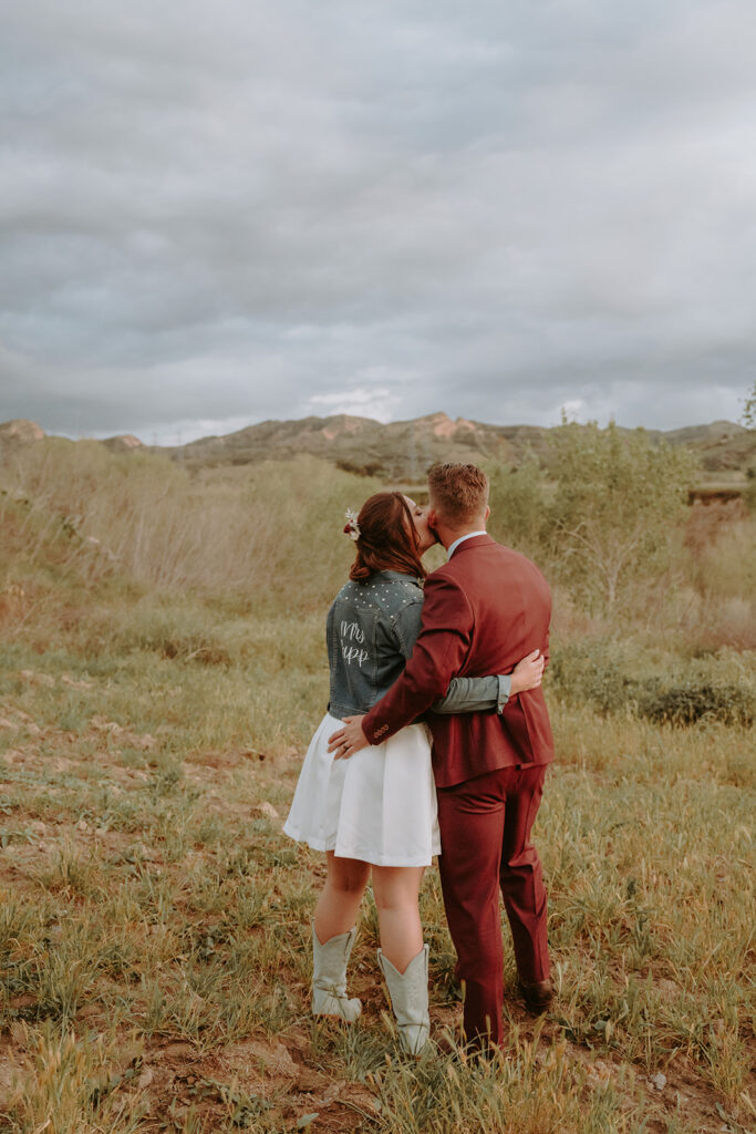 bride and groom kissing on a ranch