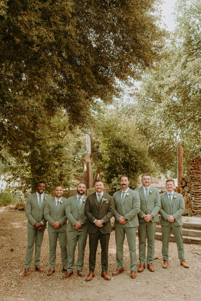 groom and groomsmen standing at an oak glen wedding venue