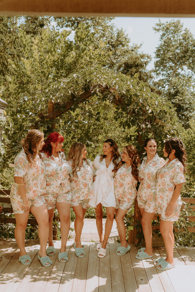 a bride posing with her bridesmaids in floral pajamas