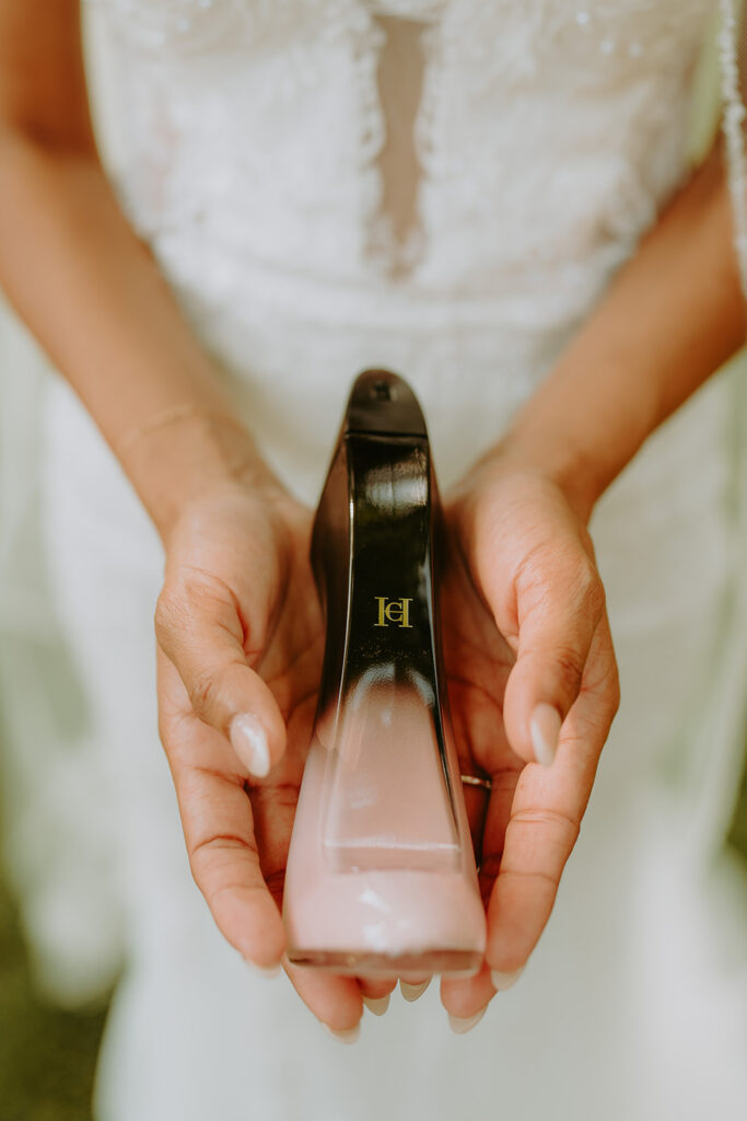 women in a wedding dress holding perfume