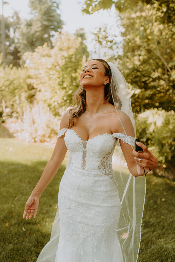 portrait of a bride putting on perfume