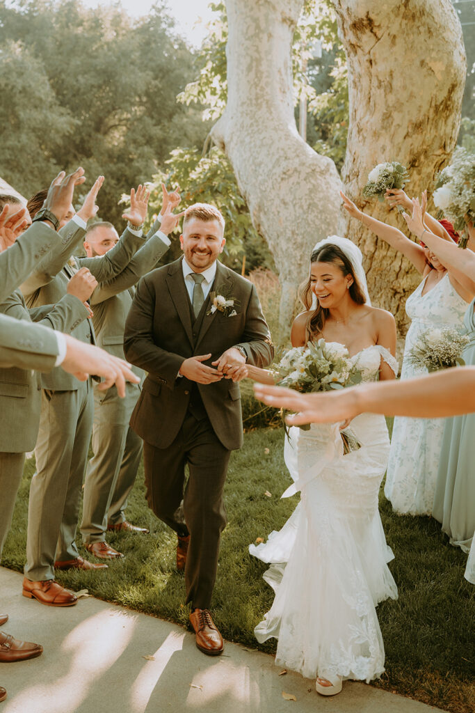 bride and groom walking with their bridal party at an oak glen wedding venue